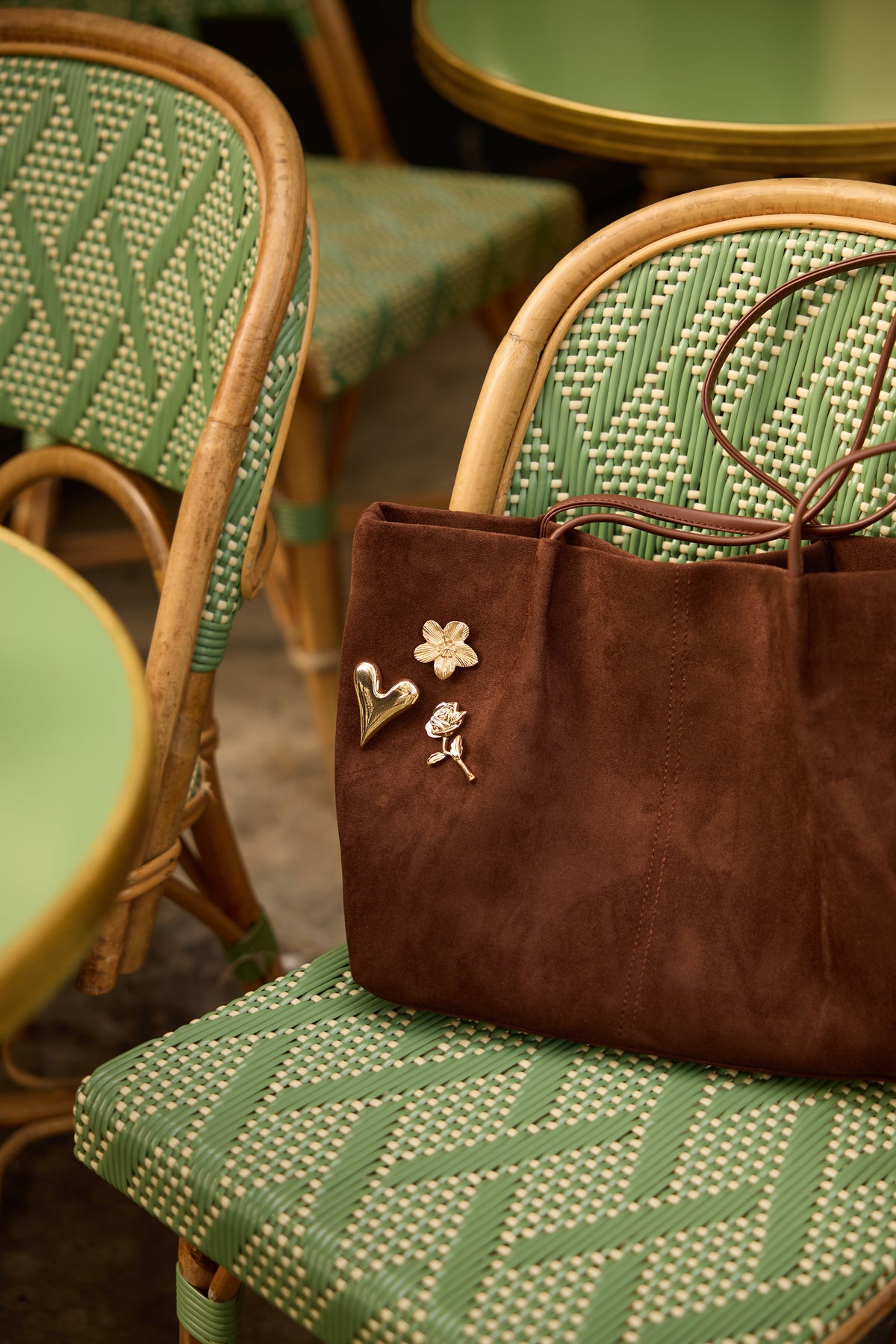 Golden Heart magnetic brooch styled on a brown suede bag together with Lara Flower and Juliette rose brooches; each design is a separate product.