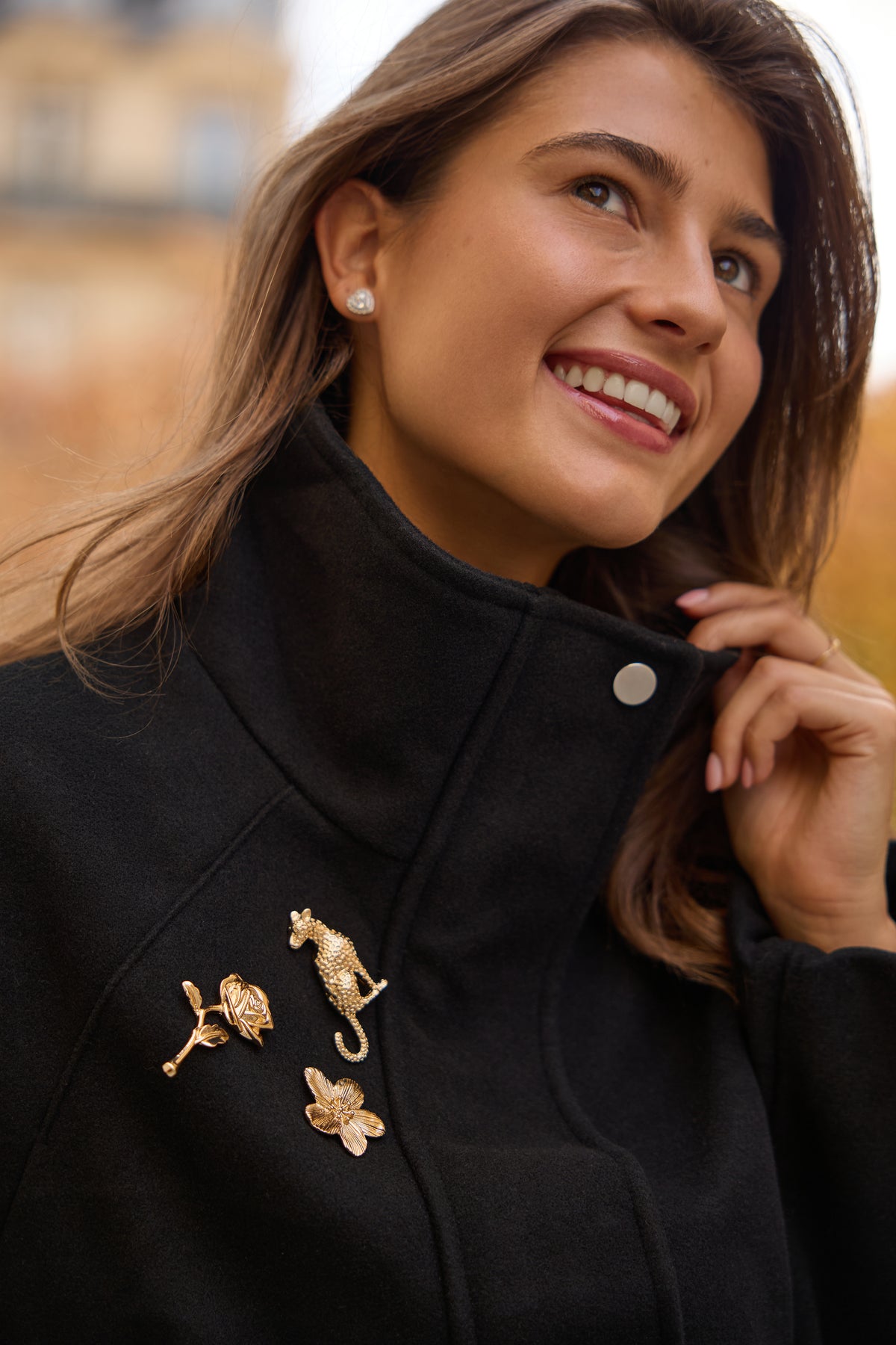 Juliette gold rose magnetic brooch on a black coat alongside Santos leopard and Lara Flower magnetic brooches; each design is a separate product.