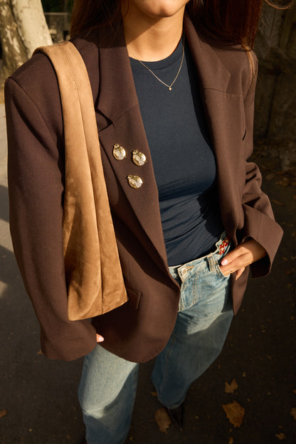 Three separate Olivia gold ladybird magnetic brooches styled on a brown blazer; styling image shows three pieces, while this product is sold individually.